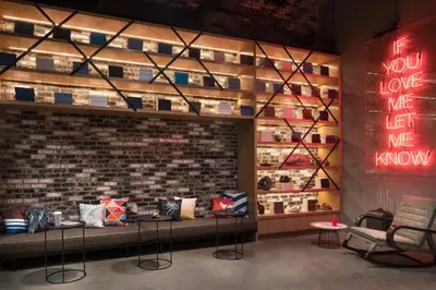 a store with a brick wall with pillows on display at Moxy San Diego Gaslamp Quarter in San Diego