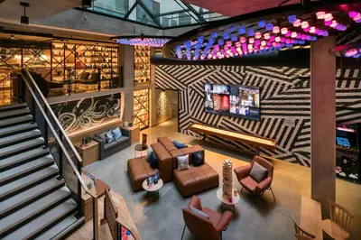 an overhead view of a living room with furniture and a staircase at Moxy San Diego Gaslamp Quarter in San Diego