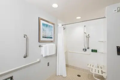 a bathroom with a shower and a shower curtain at Courtyard by Marriott San Diego Oceanside in Oceanside
