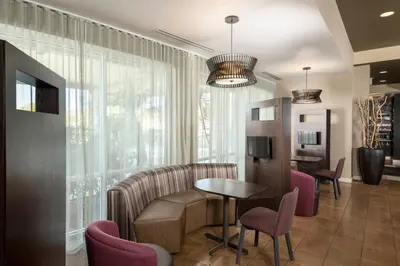 a waiting room with a table and chairs at Courtyard by Marriott San Diego Oceanside in Oceanside