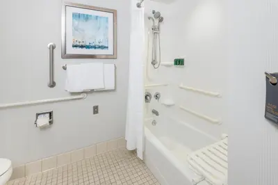 a bathroom with a tub and a toilet and a shower at Courtyard by Marriott San Diego Oceanside in Oceanside