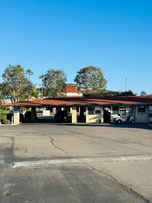 an empty parking lot in front of a gas station at Franciscan Inn Motel in Vista