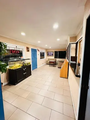 a large room with a kitchen with a tile floor at Franciscan Inn Motel in Vista