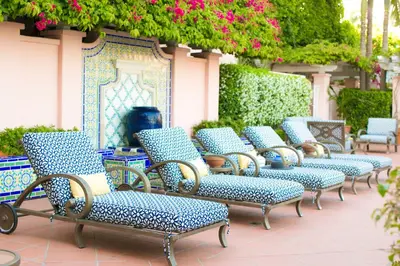 a row of chairs sitting on a patio at La Valencia Hotel in San Diego