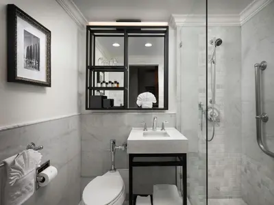 a bathroom with a toilet and a sink and a shower at La Valencia Hotel in San Diego