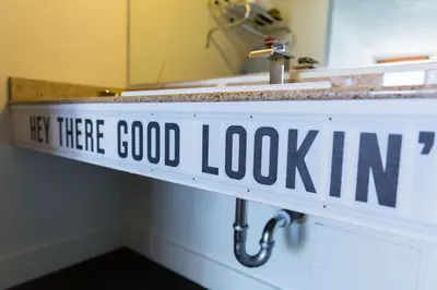 a sign that says if there is a good lookin under a sink at Rambler Hotel in Chula Vista