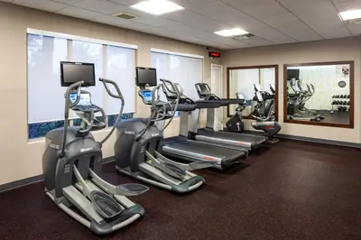 a gym with several tread machines in a row at Residence Inn by Marriott San Juan Capistrano in San Juan Capistrano