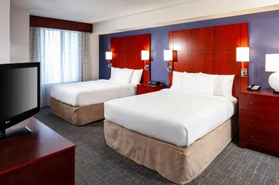 a hotel room with two beds and a flat screen tv at Residence Inn by Marriott San Juan Capistrano in San Juan Capistrano