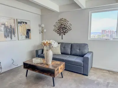 a living room with a couch and a table at Little Italy Modern Lofts in San Diego
