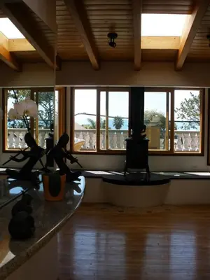 a living room with windows and a wooden floor at Secret Garden Inn in San Diego