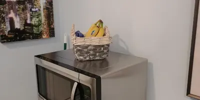 a basket of fruit sitting on top of a microwave at Casa Tranquility in San Diego