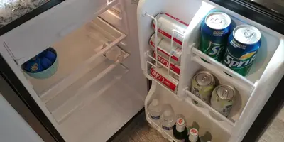 an open refrigerator filled with drinks and sodas at Casa Tranquility in San Diego