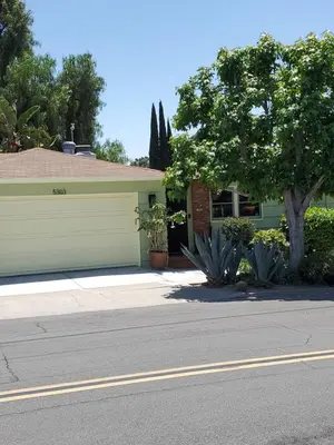 a house with a tree in front of a street at Casa Tranquility in San Diego