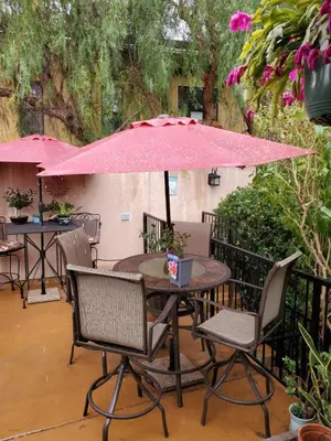 a table and chairs under an umbrella in the rain at Casa Tranquility in San Diego