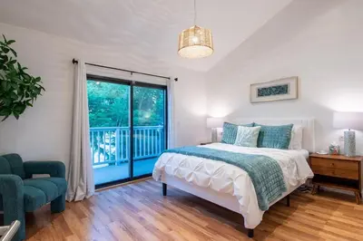 a bedroom with a bed and a large window at Luxury Retreat • Hot Tub FirePit Panoramic Views in San Diego