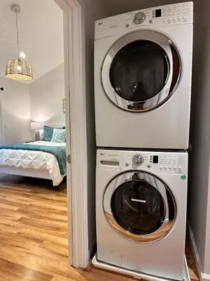 a washer and dryer in a room with a bedroom at Luxury Retreat • Hot Tub FirePit Panoramic Views in San Diego