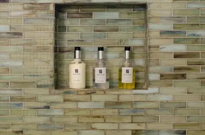 four bottles of wine are on a brick wall at Luxury Retreat • Hot Tub FirePit Panoramic Views in San Diego