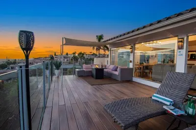 a deck with two chairs and a table on a house at Luxury Retreat • Hot Tub FirePit Panoramic Views in San Diego