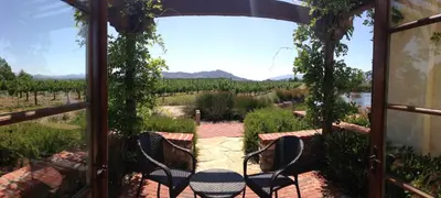 a patio with a table and chairs and a view at Ponte Vineyard Inn in Temecula