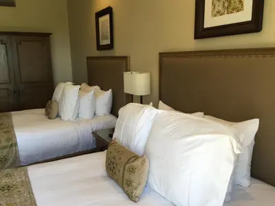 a hotel room with two beds with white pillows at Ponte Vineyard Inn in Temecula