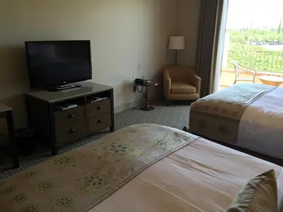 a hotel room with a bed and a flat screen tv at Ponte Vineyard Inn in Temecula