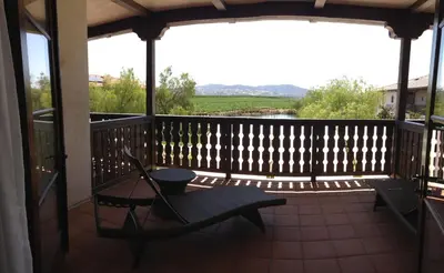 a screened in porch with a table and chairs on it at Ponte Vineyard Inn in Temecula