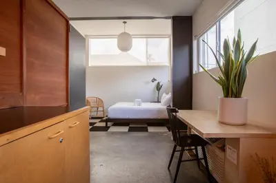 a kitchen with a table and a bedroom with a bed at Abpopa Hillcrest in San Diego