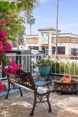 a park bench sitting in front of a fire pit at The Patriots Boutique Motel in San Clemente