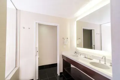 a bathroom with a sink and a mirror at DoubleTree by Hilton San Diego-Mission Valley in San Diego