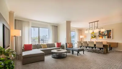 a living room with a couch and a dining room at DoubleTree by Hilton San Diego-Mission Valley in San Diego