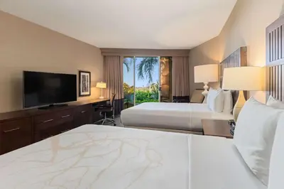 a hotel room with two beds and a flat screen tv at Hilton La Jolla Torrey Pines in San Diego
