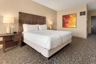 a hotel room with a large bed and a desk at Hilton La Jolla Torrey Pines in San Diego
