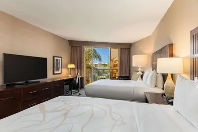 a hotel room with two beds and a flat screen tv at Hilton La Jolla Torrey Pines in San Diego