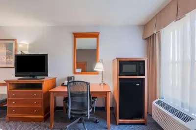 a hotel room with a desk and a television at Hampton Inn San Marcos in San Marcos