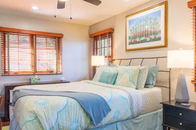 a bedroom with a bed and two windows at The Little Pumpkin Guest House in San Diego