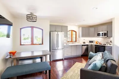a kitchen with a couch and a table in a room at The Little Pumpkin Guest House in San Diego