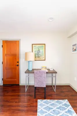 a desk with a lamp and a chair in a room at The Little Pumpkin Guest House in San Diego