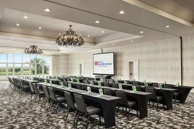 a conference room with tables and chairs and a screen at Hilton Garden Inn Carlsbad Beach in Carlsbad