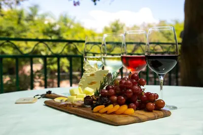 two glasses of wine and a tray of cheese and fruit at South Coast Winery Resort & Spa in Temecula
