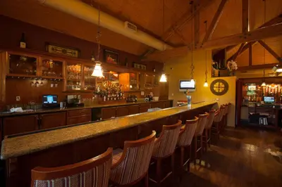 a bar in a restaurant with a bunch of chairs at South Coast Winery Resort & Spa in Temecula