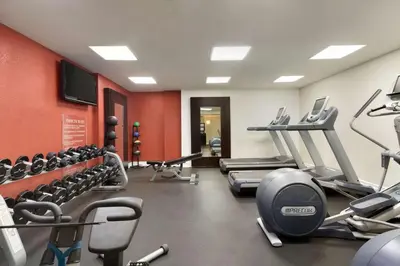 a gym with several treadmills and cardio machines at Embassy Suites by Hilton Temecula Valley Wine Country in Temecula