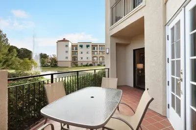 a patio with a table and chairs on a balcony at Embassy Suites by Hilton Temecula Valley Wine Country in Temecula