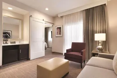 a living room with a couch and a chair at Embassy Suites by Hilton Temecula Valley Wine Country in Temecula