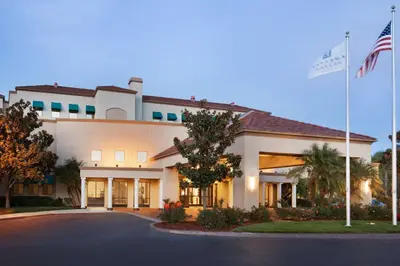 a hotel with an american flag in front of it at Embassy Suites by Hilton Temecula Valley Wine Country in Temecula
