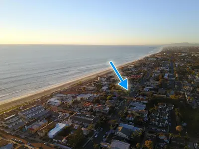 an aerial view of a beach with a blue arrow at Ultimate Beach Bungalow - 1 block from beach - huge backyard in Carlsbad