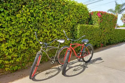 a couple of bikes parked next to a hedge at Ultimate Beach Bungalow - 1 block from beach - huge backyard in Carlsbad