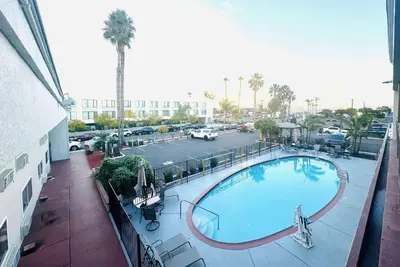 arial view of a swimming pool on a building with a parking lot at Ramada by Wyndham San Diego Airport in San Diego