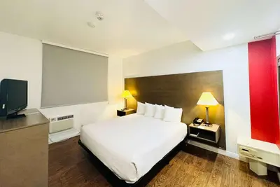 a hotel room with a bed and a flat screen tv at Ramada by Wyndham San Diego Airport in San Diego