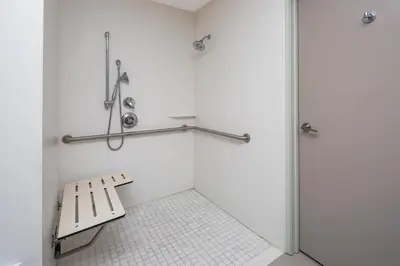 a bathroom with a bench and a shower at Holiday Inn Express San Diego Airport-Old Town by IHG in San Diego