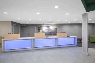 an office lobby with a reception desk and chairs at Holiday Inn Express San Diego Airport-Old Town by IHG in San Diego